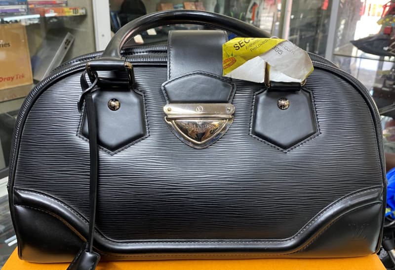 Grey louis vuitton handbag hi-res stock photography and images