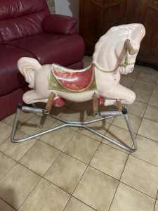 Vintage rocking horse on springs with wooden foot bars