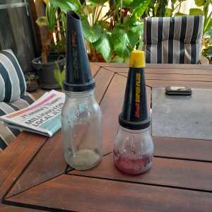 2 vintage oil bottles 