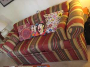 Three seat couch in firm condition with cashions