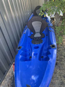 Two man kayak with paddles and life jacket.