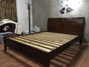 Nearly new dark solid wood queen size bed with thick wooden slats