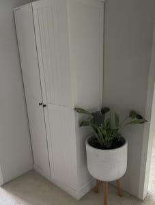White wooden shelved linen cupboard