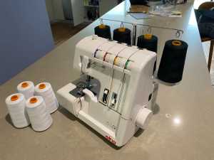 Overlocker Sewing machine(Elna), 8 large cotton rolls Carrybag cover