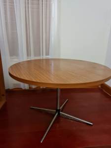 Free, laminated round dining table, steel centre leg. 