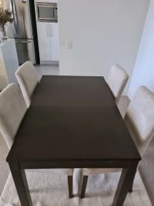 Large solid wood dining table with a suede seat