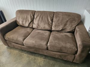 Brown three seater fold out sofa couch