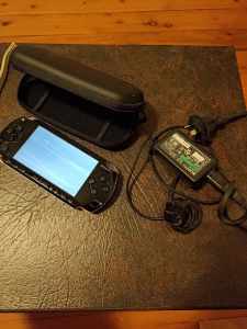 PLAYSTATION PORTABLE WITH NEW BATTERY, CARRY CASE AND CHARGER
