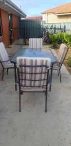 Free Outdoor Metal Frame Glass Top Table and Chairs with Cushions.