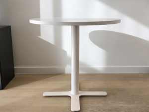 White round cafe size table with cross base