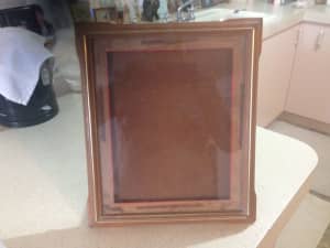 Photo frame with carved wooden exterior 