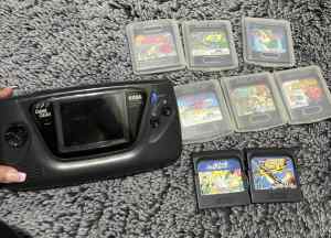Sega hand held game gear with 8 games, books & case
