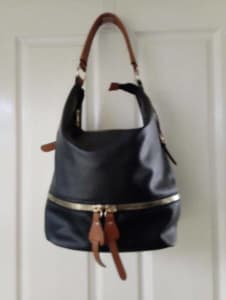 Black shoulder bag with Tan trim.Zippered pocket on back.As new