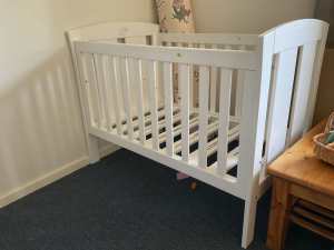White wooden cot.