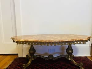 Stone top cast metal base coffee table 
