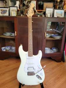 white Squier stratacaster with extra pick-up 