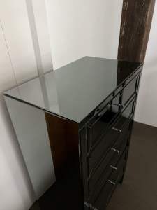 Selling mirrored glass beside table and drawers