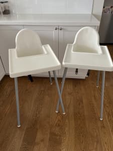 Two white IKEA high chairs. Used at grandmas house for the twins.
