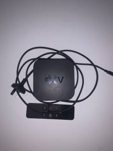 Apple TV with a remote, cable and Apple TV box