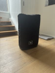 JBL PRX615 with a cover and stand.