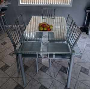 Glass dinning table with 5 seats. pick up port kembla