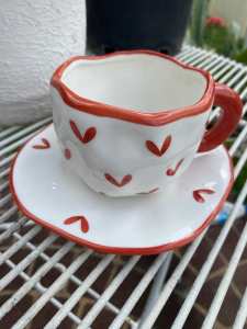 Ceramic teacup and saucer red hearts