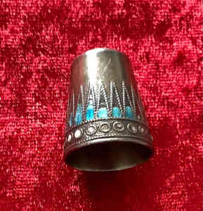 Antique silver thimble inlaid with blue and white stones
