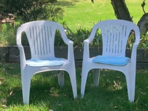35 Stackable white plastic chairs