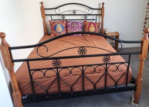 Doublesize bed frame with mattress and sidetable