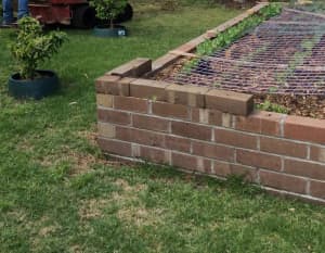 Build a raised garden bed with bricks