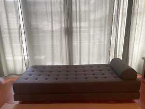 Quilted daybed with roll cushion, converts to queen size floor bed.