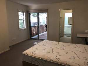 Large ensuite room with balcony and walk in wardrobe