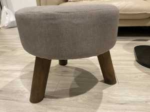 Grey footstool with wood legs