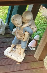 garden ornament - boy carrying child on back