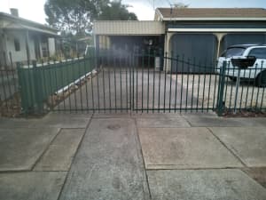 Green tubular fence with gates