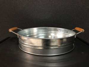 large round galvanized metallic serving tray with wooden handles