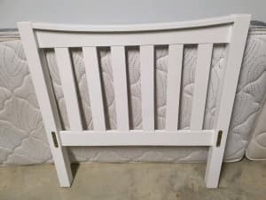 White wooden single slat bed frame with trundle
