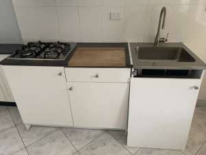 A set of kitchen cabinet with a sink and a EVERDURE gas cooktop.