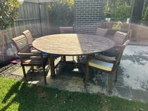 Large round garden table with 8 chairs