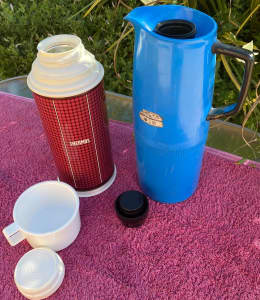 2 Thermos brand thermoses about 4 cups capacity each. One has a cup. M