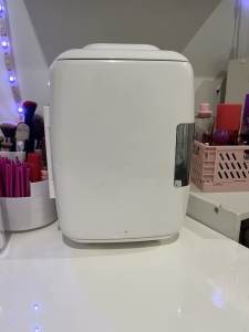 White mini fridge/cosmetics cooler.