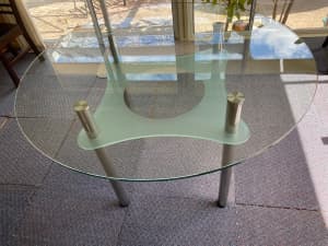 Elegant round glass top dining table with shelf under the top