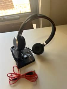Jabra Evolve 65 stereo Bluetooth headset with charging stand.