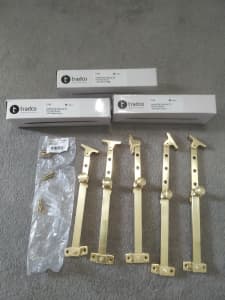 Five Tradco polished brass casement stays