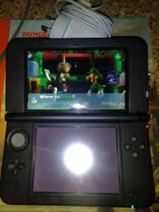 Nintendo 3DS XL console with game