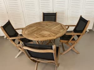 Solid teak fold away table with four comfortable chairs