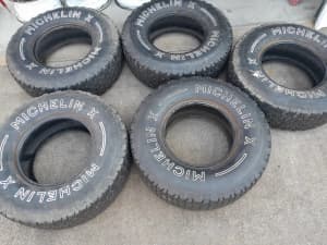 Old off road tyres beach dweller 4WD farm use, glass coffee table top.