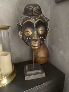 African mask with Nigerian coins