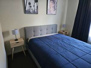 Queen size bed with mattress, bedside tables and lamps