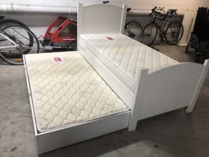 White adult size single bed with trundle and mattresses